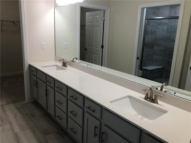 bathroom with vanity, toilet, and walk in shower