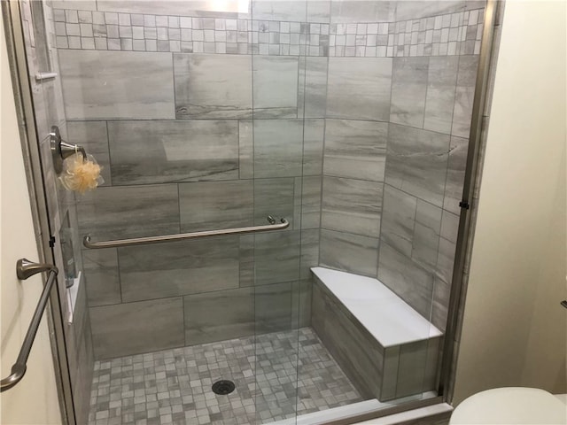 bathroom featuring toilet and walk in shower