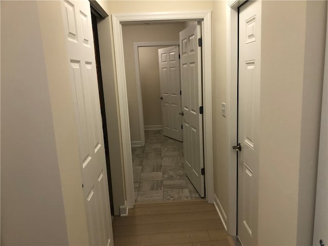 hallway featuring dark hardwood / wood-style flooring