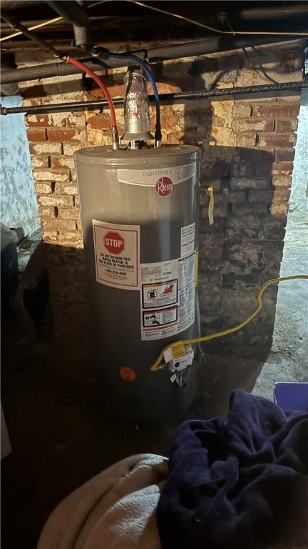 utility room featuring water heater