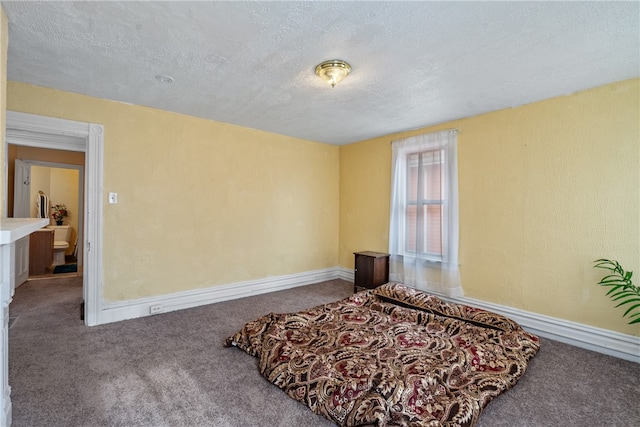 bedroom featuring carpet floors and a textured ceiling