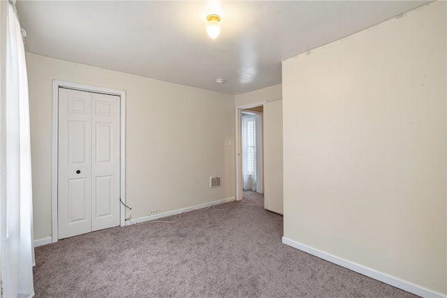 spare room featuring light colored carpet