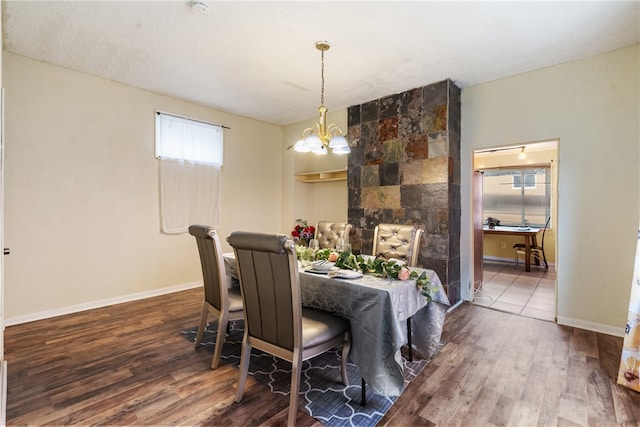 dining area featuring hardwood / wood-style floors and a notable chandelier