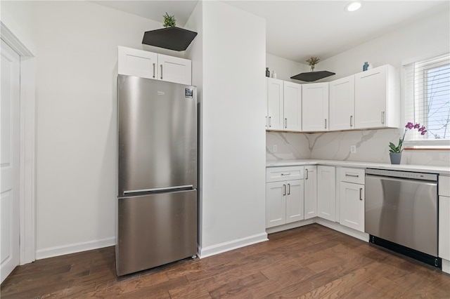 kitchen with dark hardwood / wood-style flooring, white cabinets, and stainless steel appliances