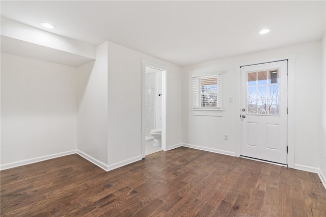 entryway with dark hardwood / wood-style flooring