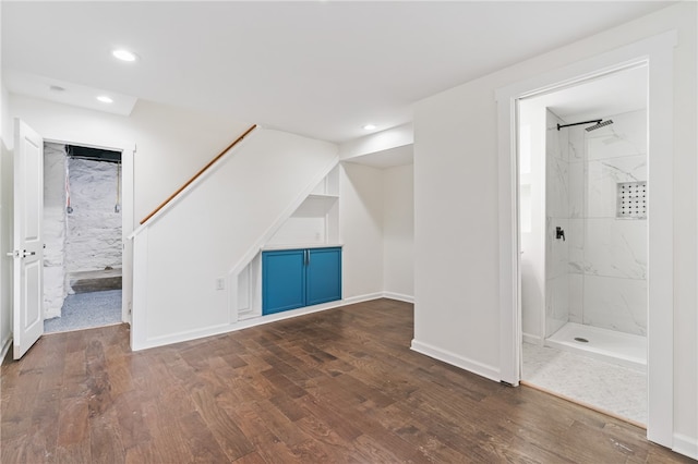 interior space with hardwood / wood-style flooring and a tile shower