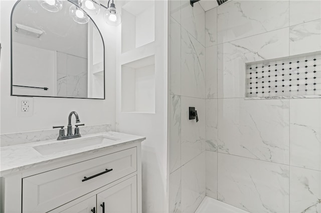 bathroom with vanity and tiled shower