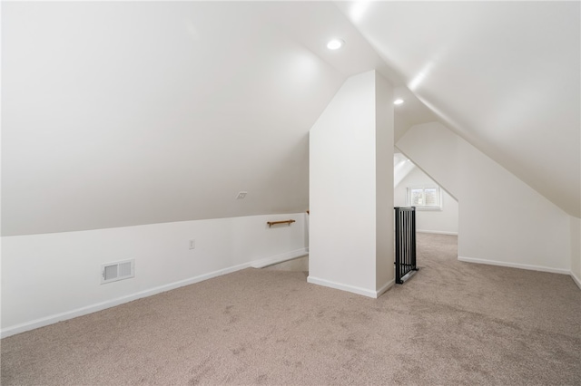 additional living space with light colored carpet and lofted ceiling