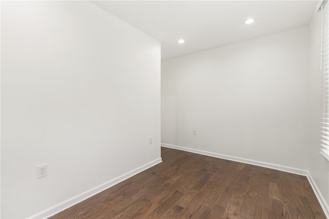 spare room featuring dark wood-type flooring