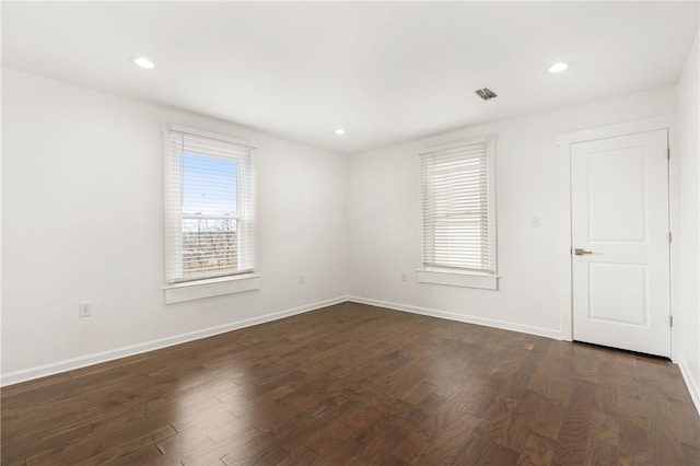 spare room with dark wood-type flooring