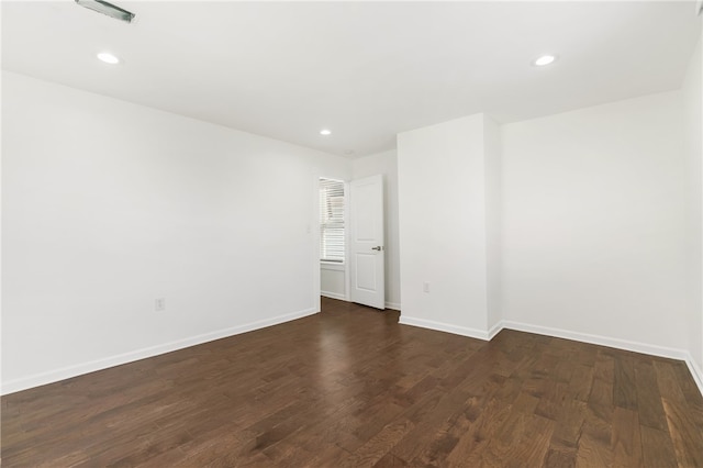 unfurnished room with dark hardwood / wood-style flooring