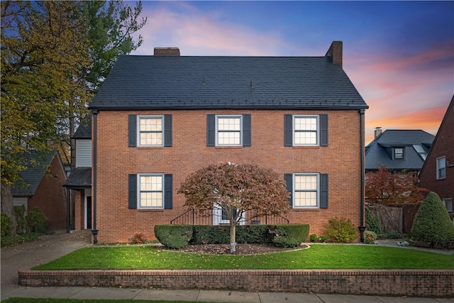 colonial-style house with a lawn