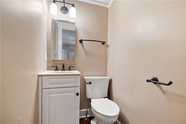 bathroom featuring vanity, toilet, and ornamental molding