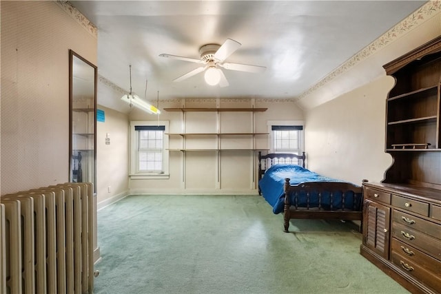 bedroom with light carpet, radiator heating unit, baseboards, and lofted ceiling