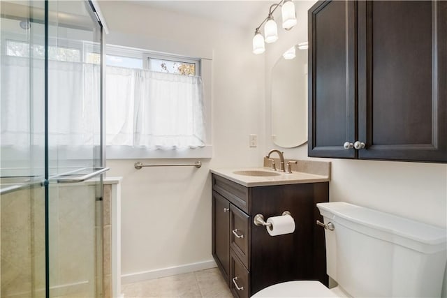 full bathroom featuring tile patterned flooring, toilet, vanity, baseboards, and an enclosed shower