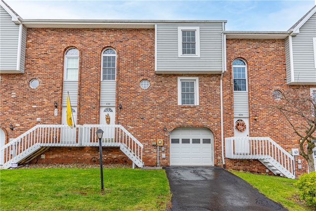 view of property with a front lawn and a garage