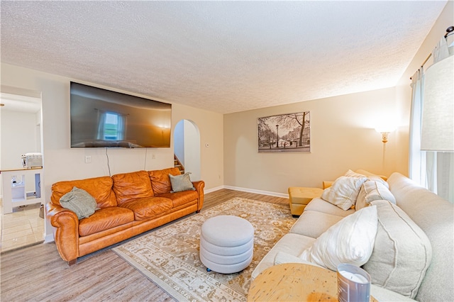 living room featuring wood-type flooring and a textured ceiling