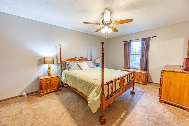 bedroom with a textured ceiling, light colored carpet, and ceiling fan