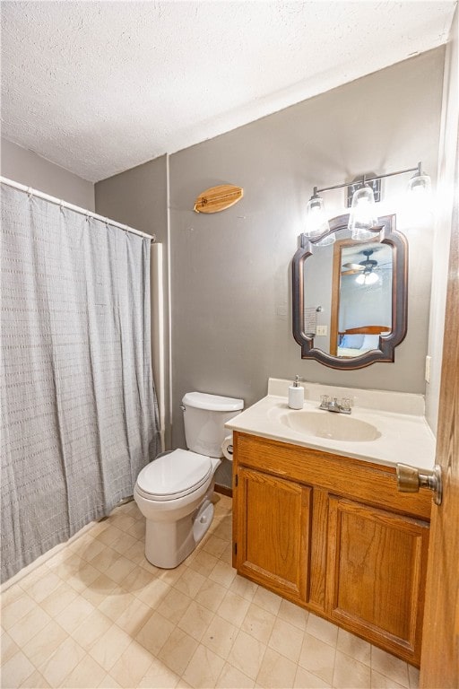 bathroom featuring vanity, a shower with curtain, a textured ceiling, and toilet