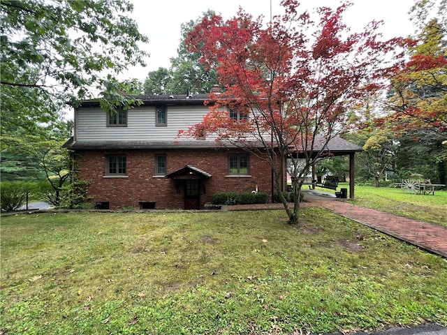 front facade with a carport and a front yard