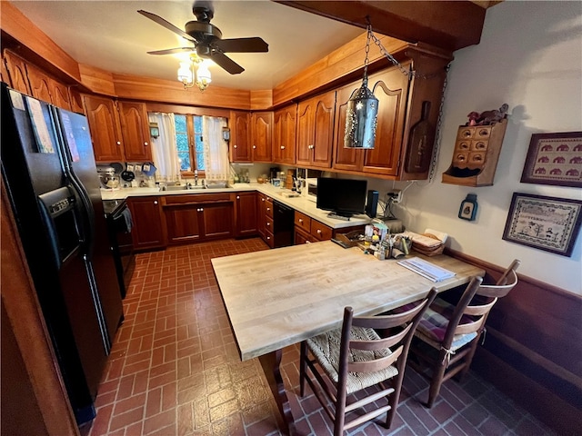 kitchen featuring ceiling fan, sink, kitchen peninsula, decorative light fixtures, and black appliances