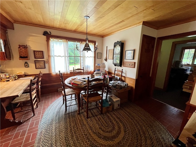 dining area with crown molding and wood ceiling