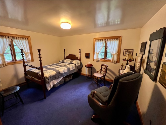 carpeted bedroom featuring multiple windows