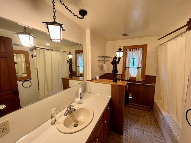 bathroom featuring vanity and shower / bathtub combination with curtain