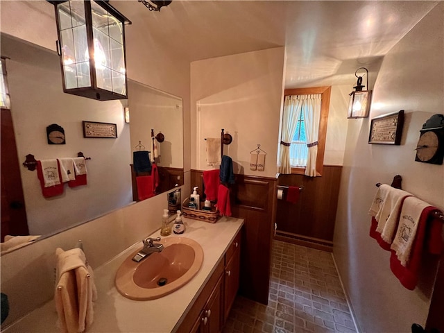 bathroom with wooden walls and vanity