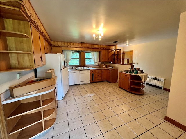 kitchen featuring light tile patterned floors, white appliances, and radiator