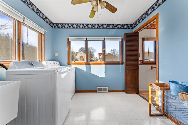 washroom featuring washing machine and clothes dryer, ceiling fan, and sink