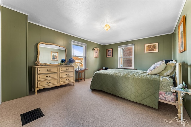 carpeted bedroom with a textured ceiling and crown molding