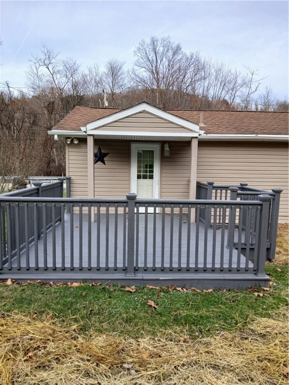 rear view of property featuring a wooden deck