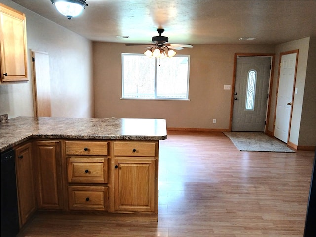 kitchen featuring ceiling fan, black dishwasher, light wood-type flooring, and kitchen peninsula