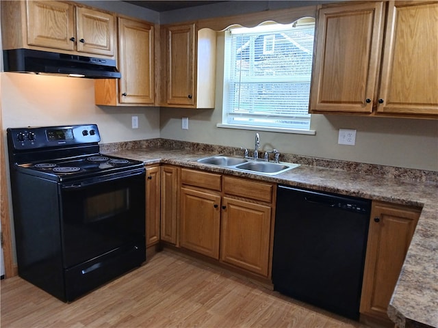 kitchen featuring black appliances, light wood-type flooring, and sink