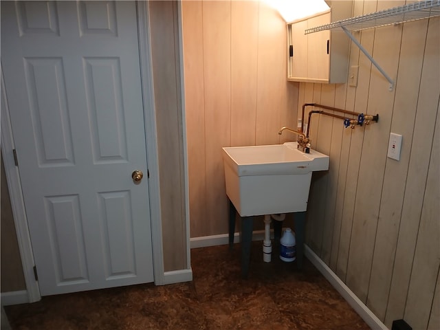 bathroom with wood walls