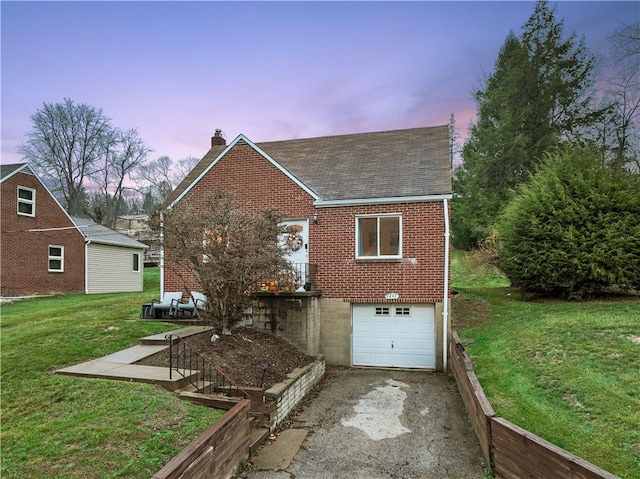 back house at dusk with a yard and a garage