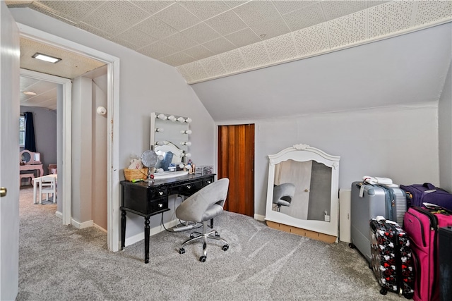 carpeted office space with vaulted ceiling