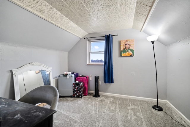 carpeted office space featuring vaulted ceiling