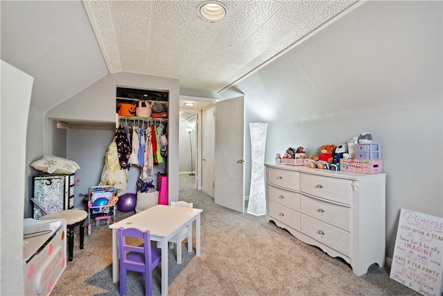 carpeted bedroom featuring a closet and vaulted ceiling