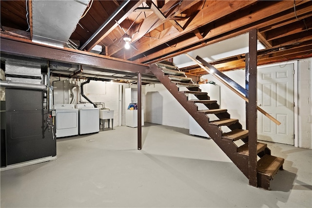 basement featuring separate washer and dryer and heating unit