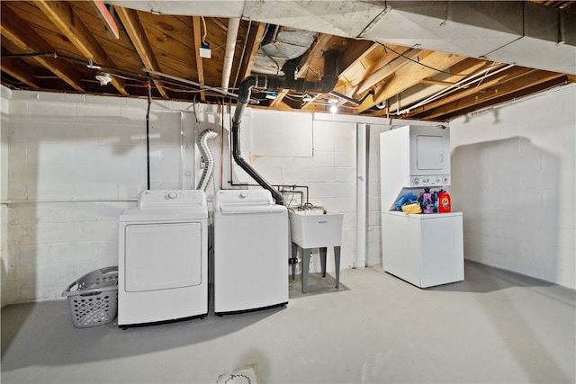 clothes washing area featuring separate washer and dryer and sink