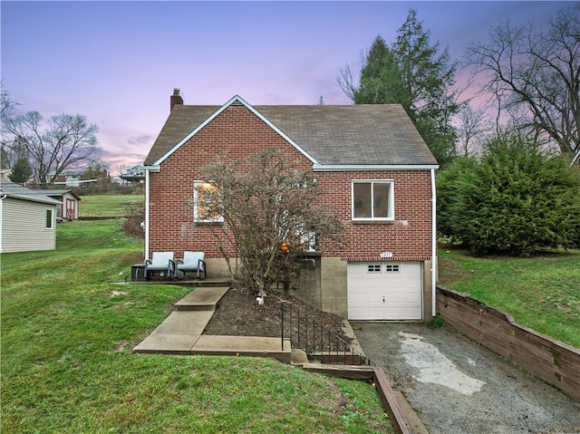 view of front of house with a yard and a garage