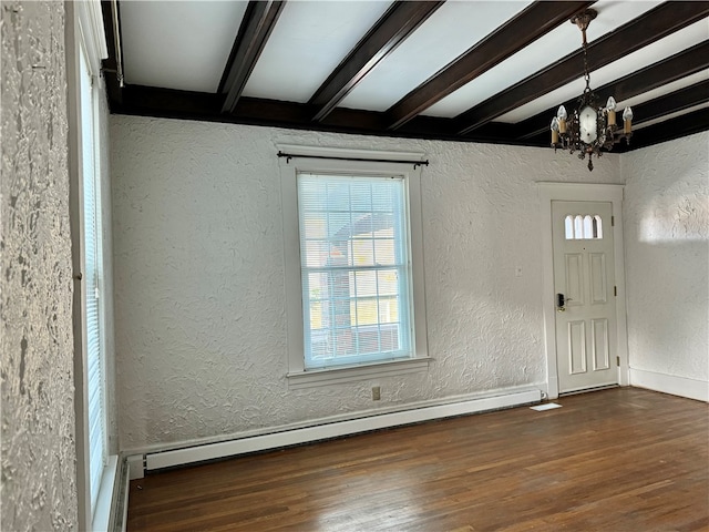 foyer entrance with beamed ceiling, dark hardwood / wood-style floors, an inviting chandelier, and a baseboard heating unit