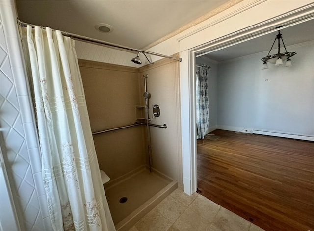 bathroom featuring curtained shower, wood-type flooring, and ornamental molding