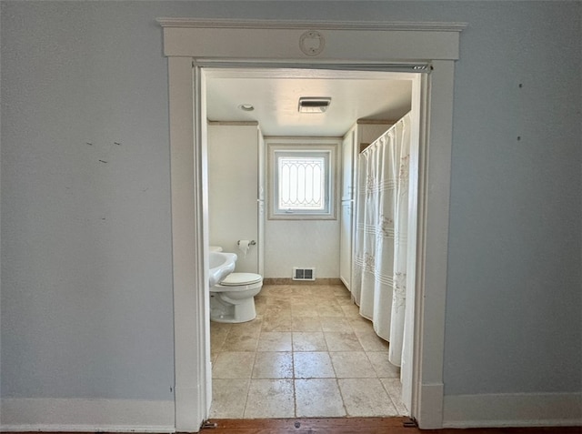 bathroom with tile patterned flooring and toilet