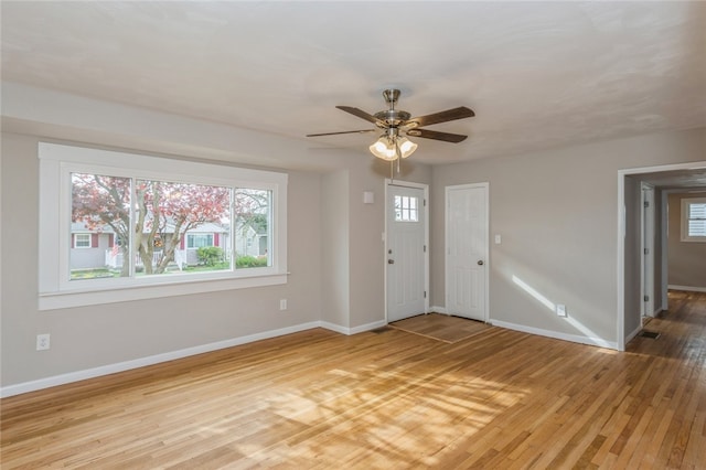 foyer with ceiling fan and wood-type flooring