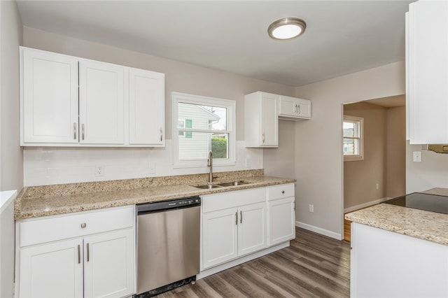 kitchen with white cabinets, sink, stainless steel dishwasher, light stone counters, and dark hardwood / wood-style flooring