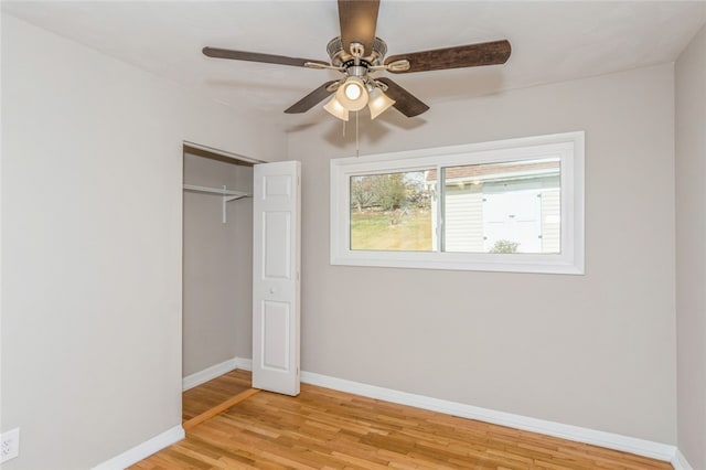 unfurnished bedroom with a closet, light hardwood / wood-style flooring, and ceiling fan