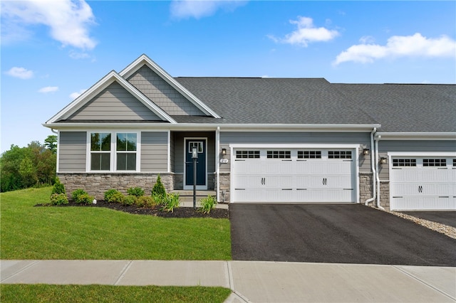 craftsman-style home with a garage and a front lawn